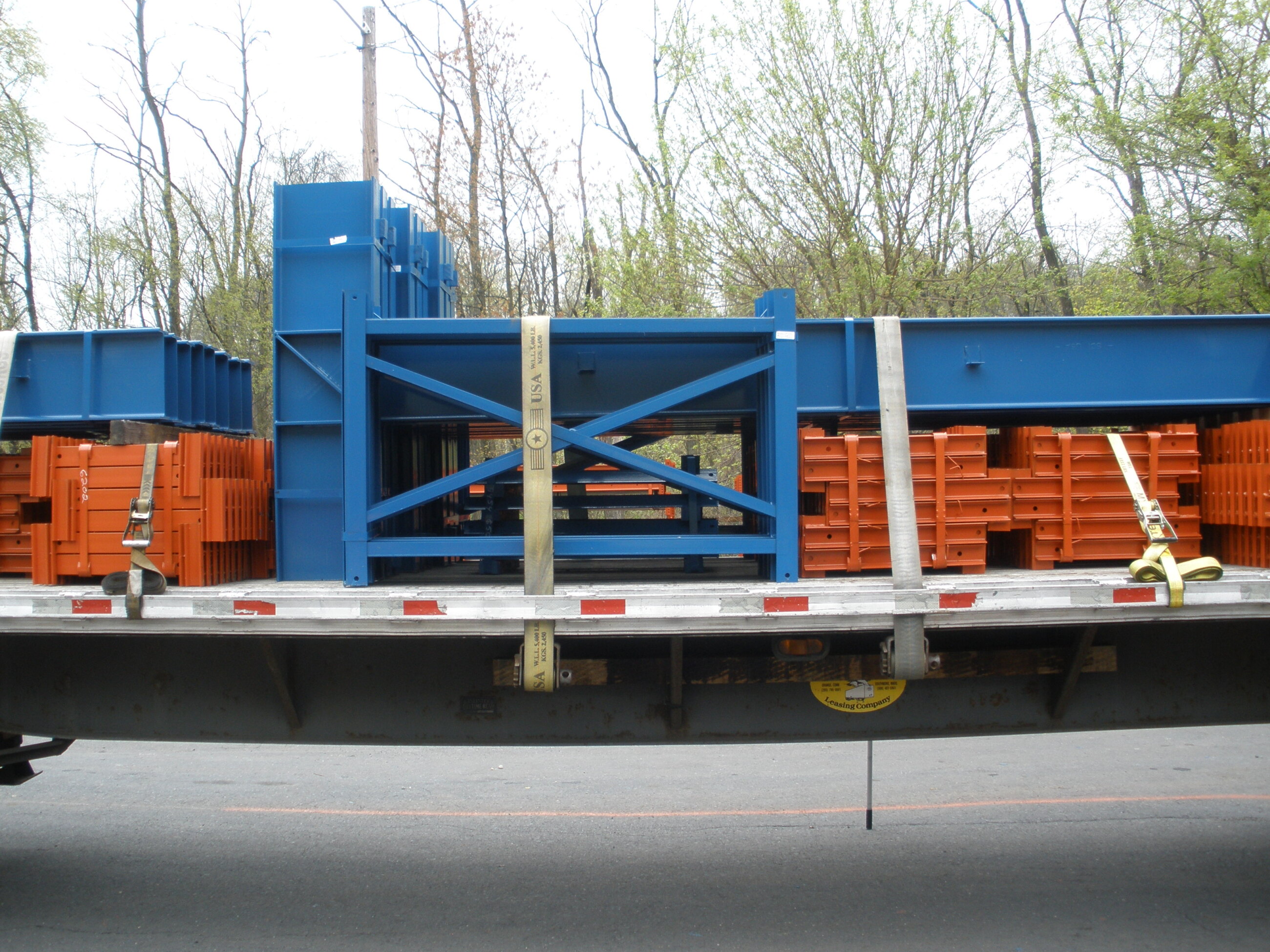 Rows of finished blue steel racking frames staged in the Walco yard