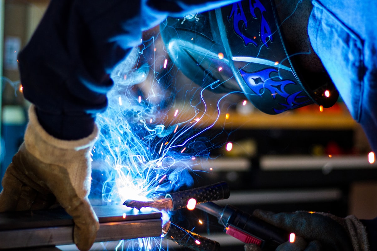 Welder striking an arc on carbon steel