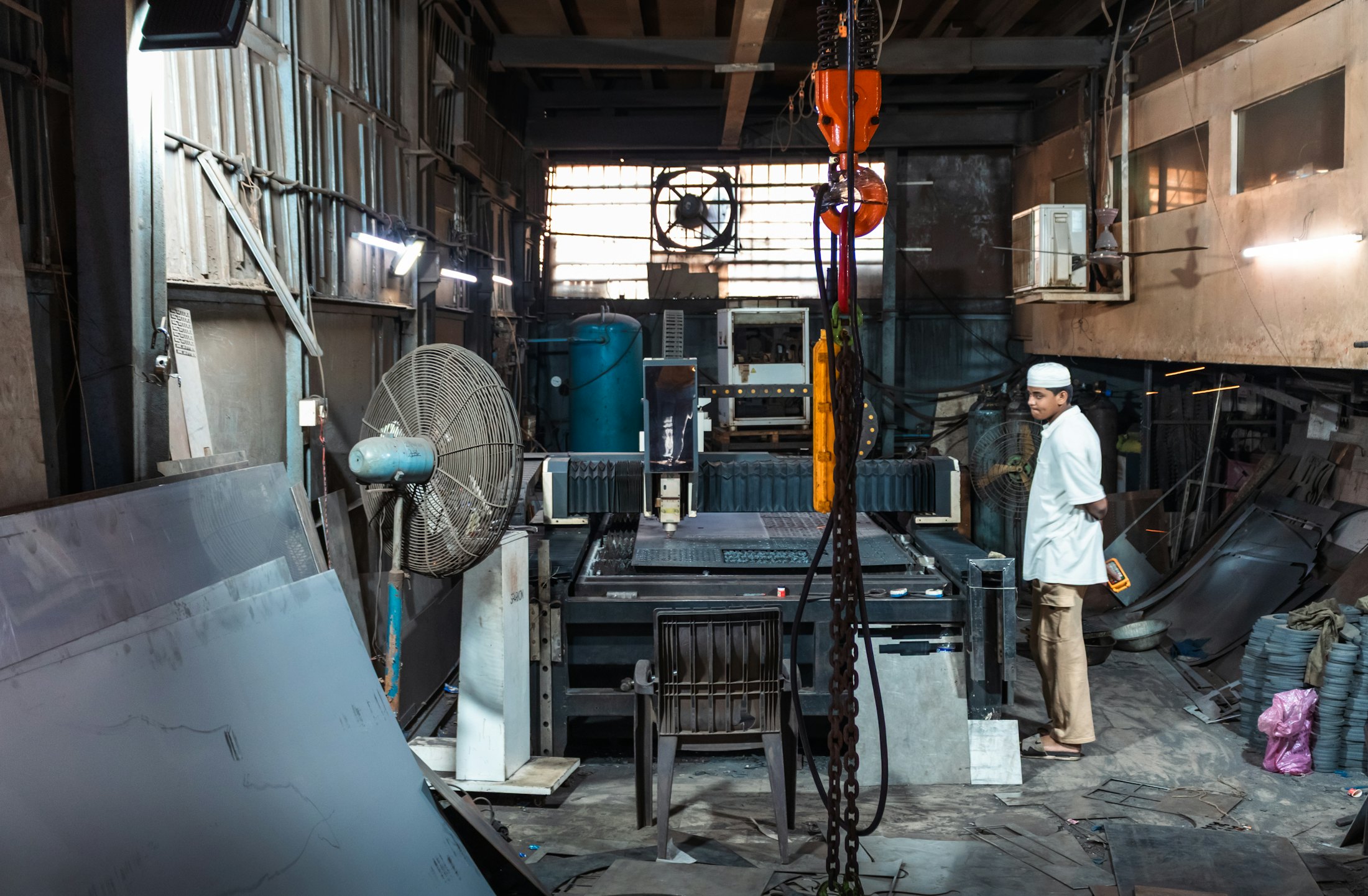 Fabricator working on a steel assembly inside the shop